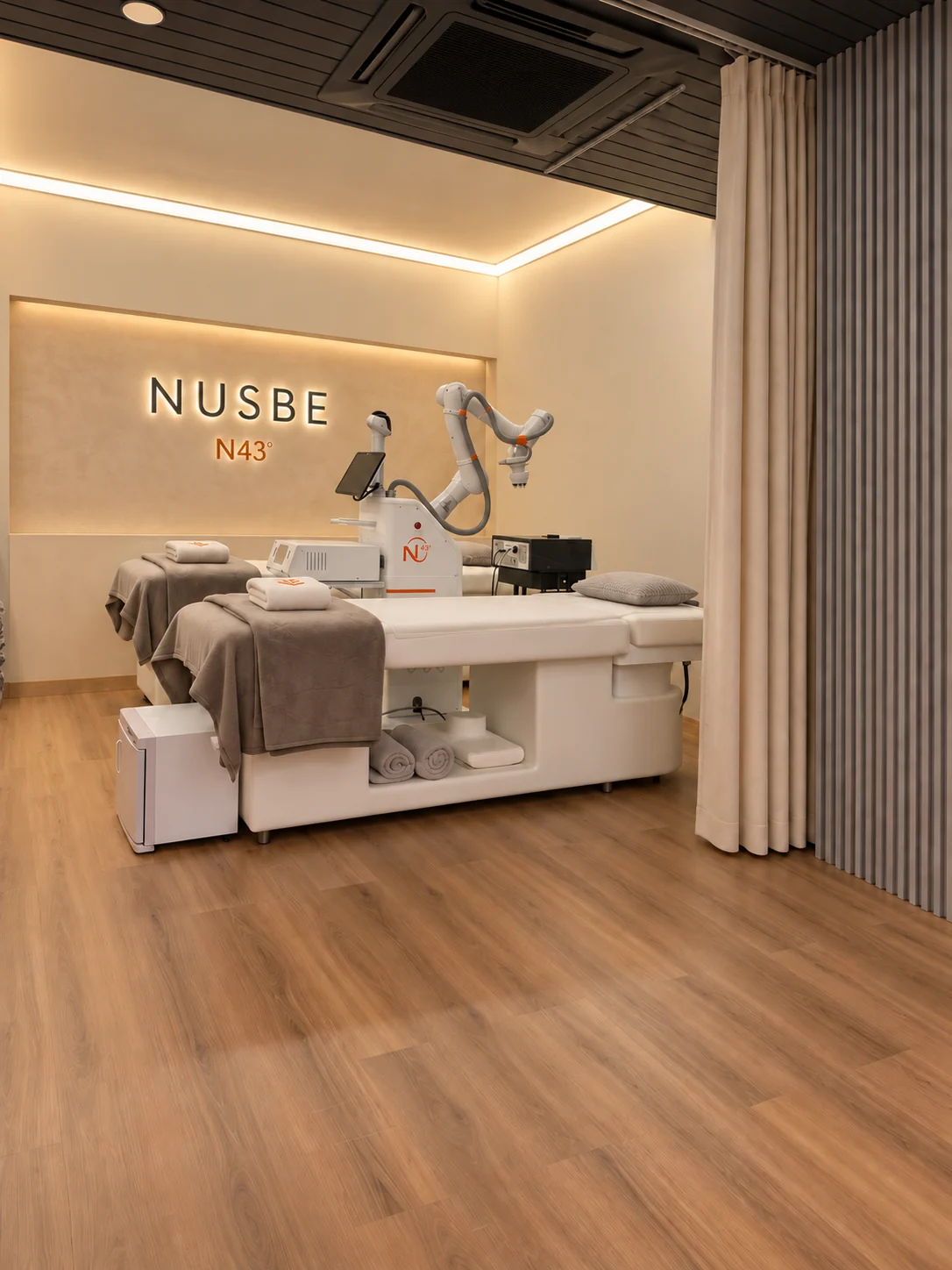 Interior design for the NUSBE Rimbayu treatment room, with robotic equipment and warm timber finishes